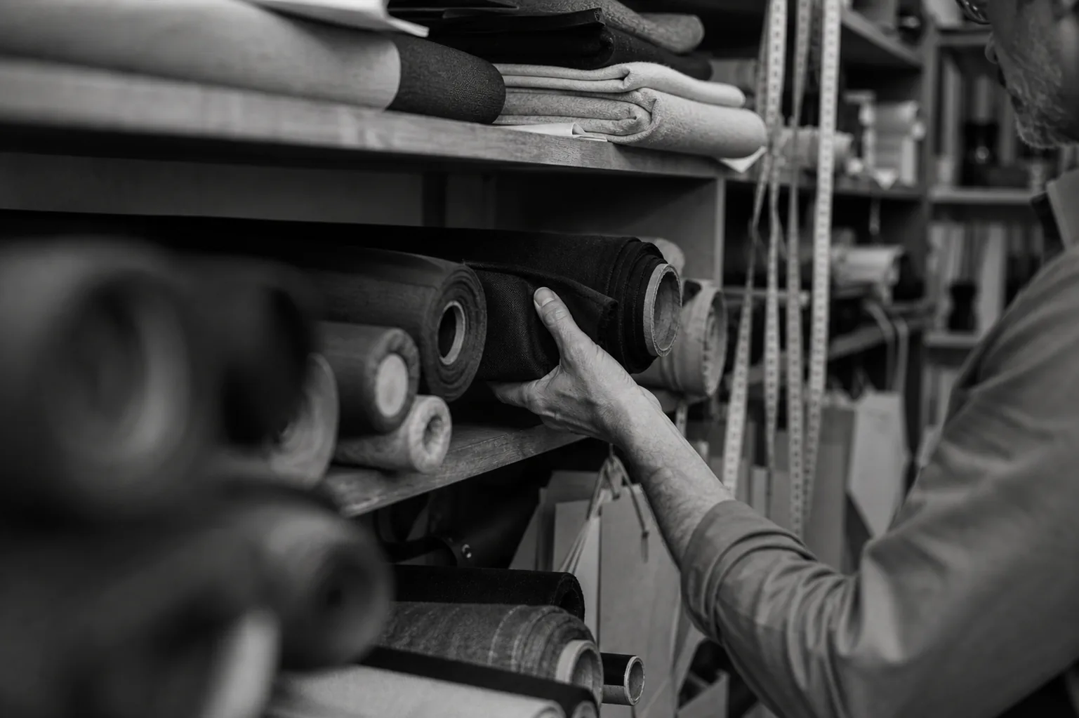 Fabric selection at the mill — rolls of material chosen for feel, stretch, and drape.